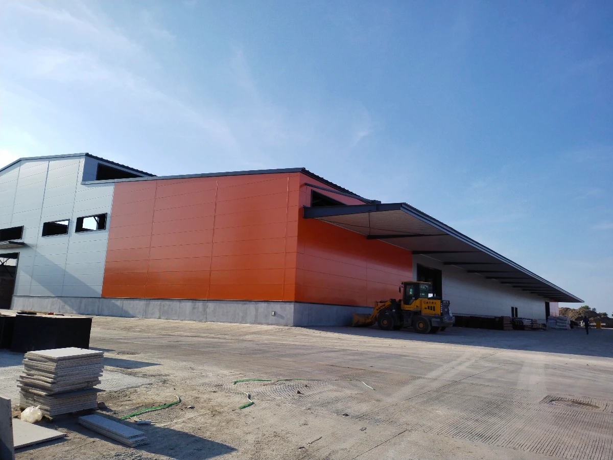 Steel warehouse loading side with a cantilevered canopy over the dispatch apron