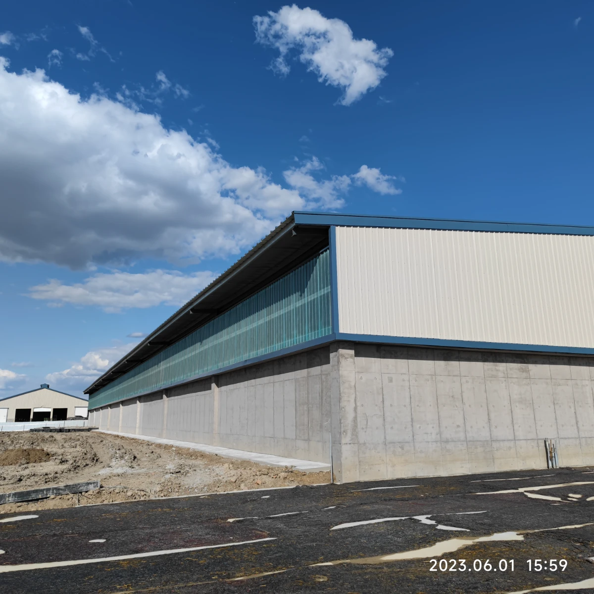 Steel dairy barn with a glazed clerestory strip along the roof bringing daylight into the building