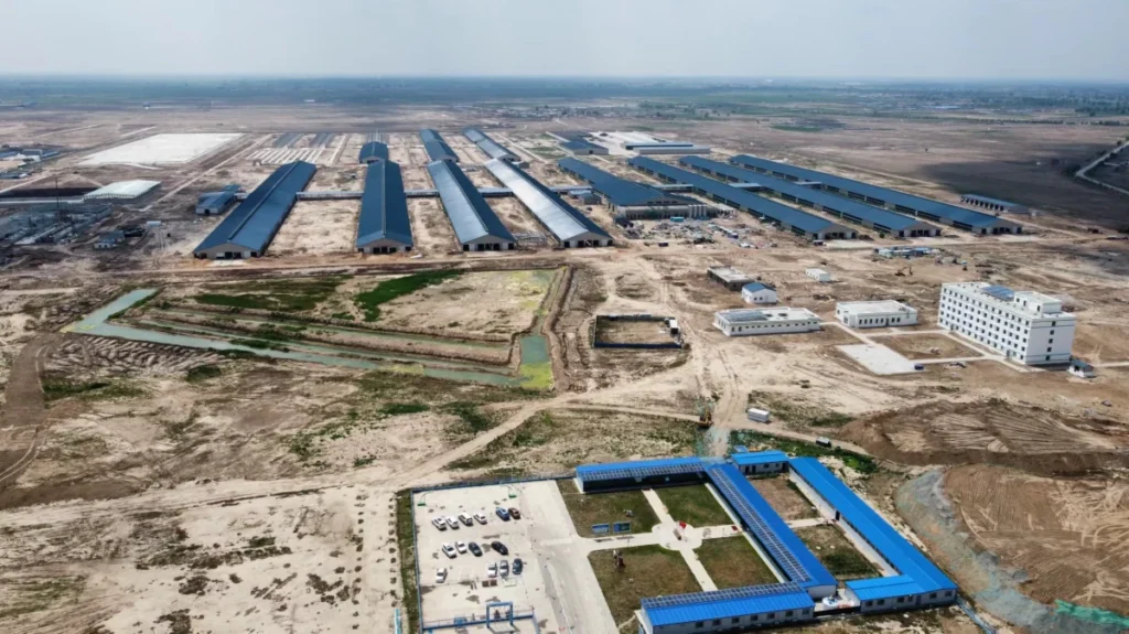 Aerial view of large-scale steel livestock and dairy farm facility operations.