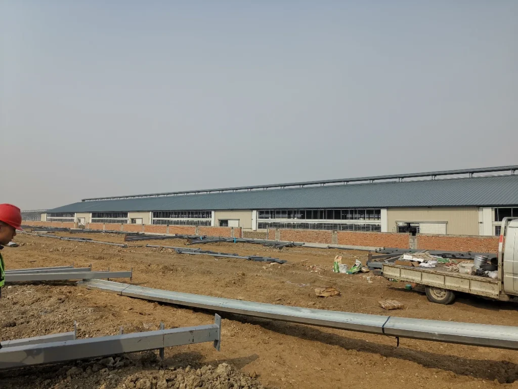 Steel structure construction site with framework, scaffolding, and prefab assembly in progress.