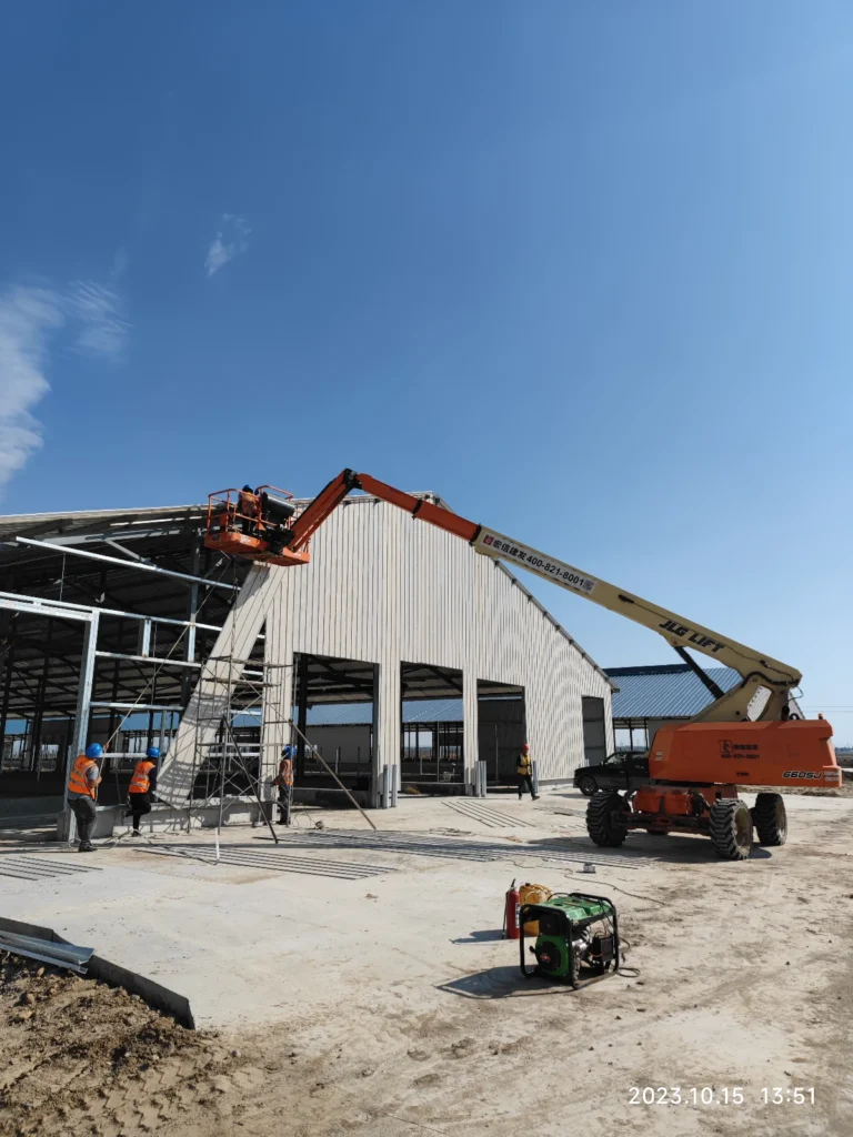 Exterior view of an insulated steel dairy barn with ventilation and weatherproof cladding.